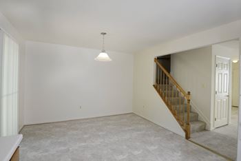 an empty living room at Carlson Woods Townhomes, Baltimore, MD
